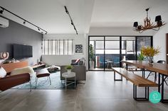 a living room filled with furniture and a flat screen tv on top of a wooden table