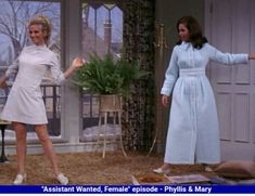 two women in white dresses are dancing on the set of an old tv show,