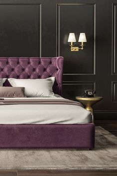 a bed with purple upholstered headboard and two lamps on either side of it