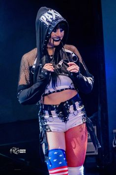 a woman in tights and boots on stage with an american flag leg garter