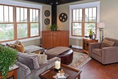 a living room filled with furniture and windows