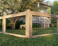 a dog is standing behind a fence in the grass near a house and some trees