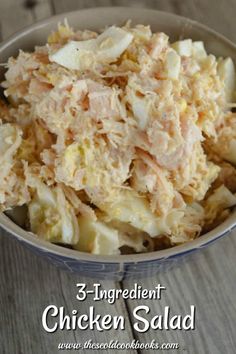 a bowl filled with chicken salad on top of a wooden table