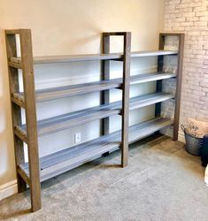 an empty room with shelves and a ladder