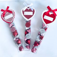 three valentine's day candy sticks with hearts in them