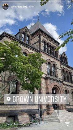 the brown university building with trees and blue sky in the background is shown on an iphone screen