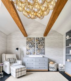 a living room with a chandelier hanging from the ceiling