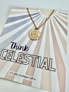 a gold necklace with the words think gelestial on it and a sunburst