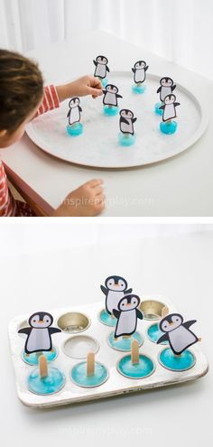 a child is playing with penguins in the water and then making popsicles for them