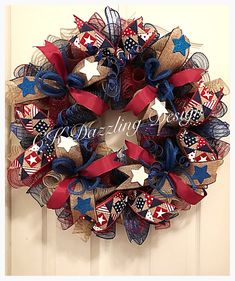 a patriotic wreath with red, white and blue ribbons