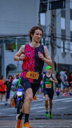 a man running in a marathon with other people behind him