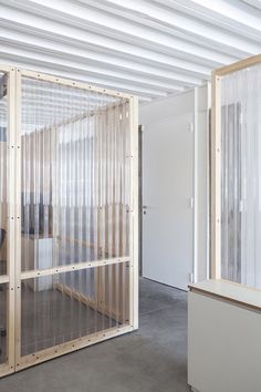 an office with glass partitions in the middle