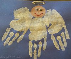 an angel made out of handprints is hanging on a blue background with gold foil