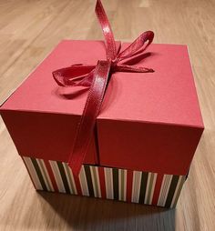 a red gift box with a ribbon on it