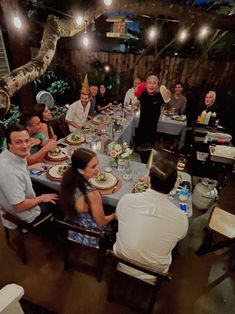 a group of people sitting around a dinner table