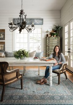 a woman sitting at a table in a room