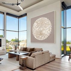 a living room filled with furniture and large windows