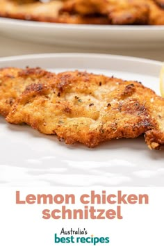 lemon chicken schnitzel on a white plate with lemon wedges in the background