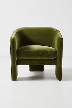 a green chair sitting on top of a white floor