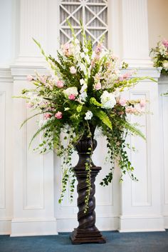 a tall vase filled with lots of flowers