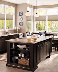 a large kitchen with lots of counter space and plates hanging on the wall above it