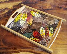 a wooden tray with stained glass designs on it