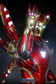 an iron man statue is shown in the dark with its arms outstretched and glowing eyes