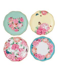 four plates with pink flowers and butterflies on them, one has blue trim around the edge