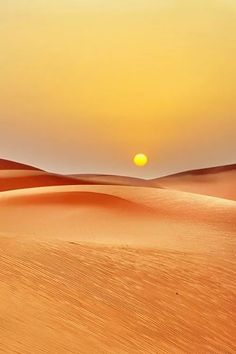 the sun is setting over sand dunes in the desert