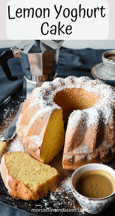 a lemon yogurt cake with powdered sugar on top and coffee in the background