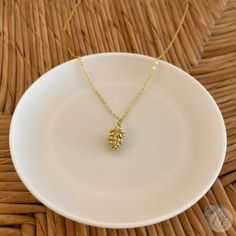 Gold Pine Cone Charm Necklace, Nature Inspired Pendant Jewellery, Petite, Minimalist, Delicate, Real Pressed Flower Necklace 'Nature' Range - Golden Pine Cone This Pine Cone pendant measures approximately 14mm x 8mm which beautifully hangs from an 18 inch gold tone plated chain. ALSO AVAILABLE IN SILVER - See shop for details. Traditionally, pine cones are a good luck charm given to a married couple forming a new family. They are symbolic of fertility and prosperity as they are full of seeds. Pine cones are the fruit of evergreen conifers and therefore also symbolise longevity and eternity.  If you have any questions please feel free to message us. Follow us on Instagram @MarionBloomMB and Facebook @MarionBloom for updates and new items! Delivery Information All orders are sent via Royal M Nature-inspired Yellow Gold Round Pendant Necklace, Pine Cone Pendant, Gold Acorn Necklace, Gold Leaf-shaped Nature-inspired Necklace, Pinecone Necklace, Pinecone Pendant, Pressed Flower Necklace, Luck Charm, Luck Charms