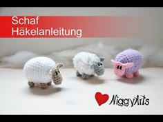 three crocheted sheep standing next to each other in front of white clouds and the words schaf hakelaneltung