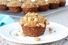 a muffin is sitting on a plate with other muffins in the background