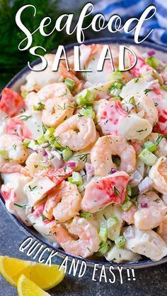 a bowl filled with shrimp salad and garnished with fresh herbs on the side