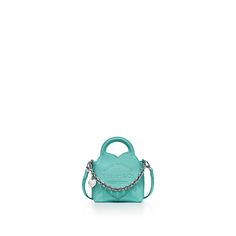 Inspired by one of the House’s most distinctive designs, the heart-shaped Return to Tiffany® handbags are crafted in supple leather and embellished with charm and chain link accents that nod to our iconic jewelry. This playful micro charm tote is embossed with our signature motif and features a palladium-plated heart tag. Tiffany Blue® calfskin leather; 4.5" W x 6.25" H x 2.25" D; Palladium-plated hardware, charms and chain link; Detachable leather strap and fixed handles; Interior slip pocket; Iconic Jewelry, Return To Tiffany, Heart Tag, Tiffany Blue, Nappa Leather, Tiffany & Co., Blue Leather, Leather Tote, Chain Link