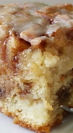 a close up of a piece of cake on a plate with a fork in it