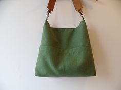 Linen and cotton sturdy canvas everyday casual slouchy hobo purse, medium bucket bag in fresh green. Exterior - High quality natural linen and cotton fabric in fresh green color - Two outside exterior slip pockets *Interior - Natural cotton in grey color. - Two inside interior pockets * Magnetic snap button closure * Real leather strap from high quality italian genuine leather in gorgeous cognac brown color. Reinforced with antique toned brass rivets. Detachable. Available in: - Cognac brown - D Canvas Hobo Bag With Pockets For Errands, Eco-friendly Green Hobo Bag For Travel, Versatile Cotton Hobo Bag For Everyday Use, Versatile Everyday Cotton Hobo Bag, Everyday Canvas Bucket Bag, Everyday Hobo Bag With Canvas Lining, Everyday Hobo Bag With Canvas Lining In Tote Shape, Everyday Canvas Bucket Hobo Bag, Green Canvas Tote Bag For Everyday