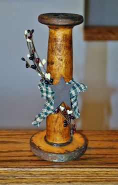 a wooden pole with a star on it and some decorations around the top, sitting on a table