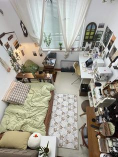 an overhead view of a small living room with furniture and pictures on the wall above it