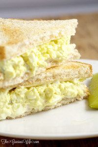 a close up of a sandwich on a plate with a pickle