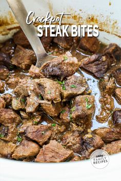 beef stew in a white bowl with a spoon on top and the words crockpot steak bites above it