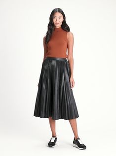 VEGAN LEATHER: Soft and smooth, this vegan leather looks and feels luxurious.  A-LINE: This flowy skirt has sunburst pleats at the waist for a flattering, A-line fit.  Invisible zip at side.  Unlined.  High waisted.  A-line fit.  Midi length.  Skirt Leather Looks, Midi Skirt Black, Black Midi Skirt, Flowy Skirt, Pleated Midi Skirt, Skirt Black, Midi Length, Banana Republic, Vegan Leather