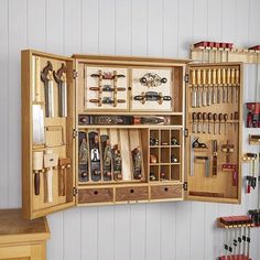 an open wooden tool box filled with lots of woodworking tools and other things in it