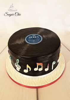 a cake with music notes on it sitting on a table