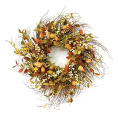 a dried wreath with red and yellow flowers on it, sitting against a white background