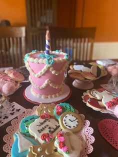 a table topped with lots of decorated cookies