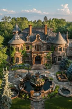 this is an aerial view of a large house with a fountain in the front yard