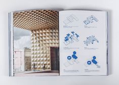 an open book with diagrams on the cover and inside pages showing different architectural structures, including a building