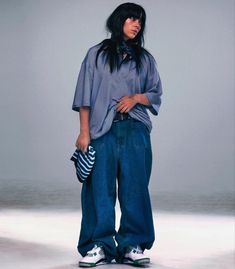 a woman with black hair wearing blue jeans