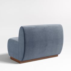 a blue couch sitting on top of a white floor